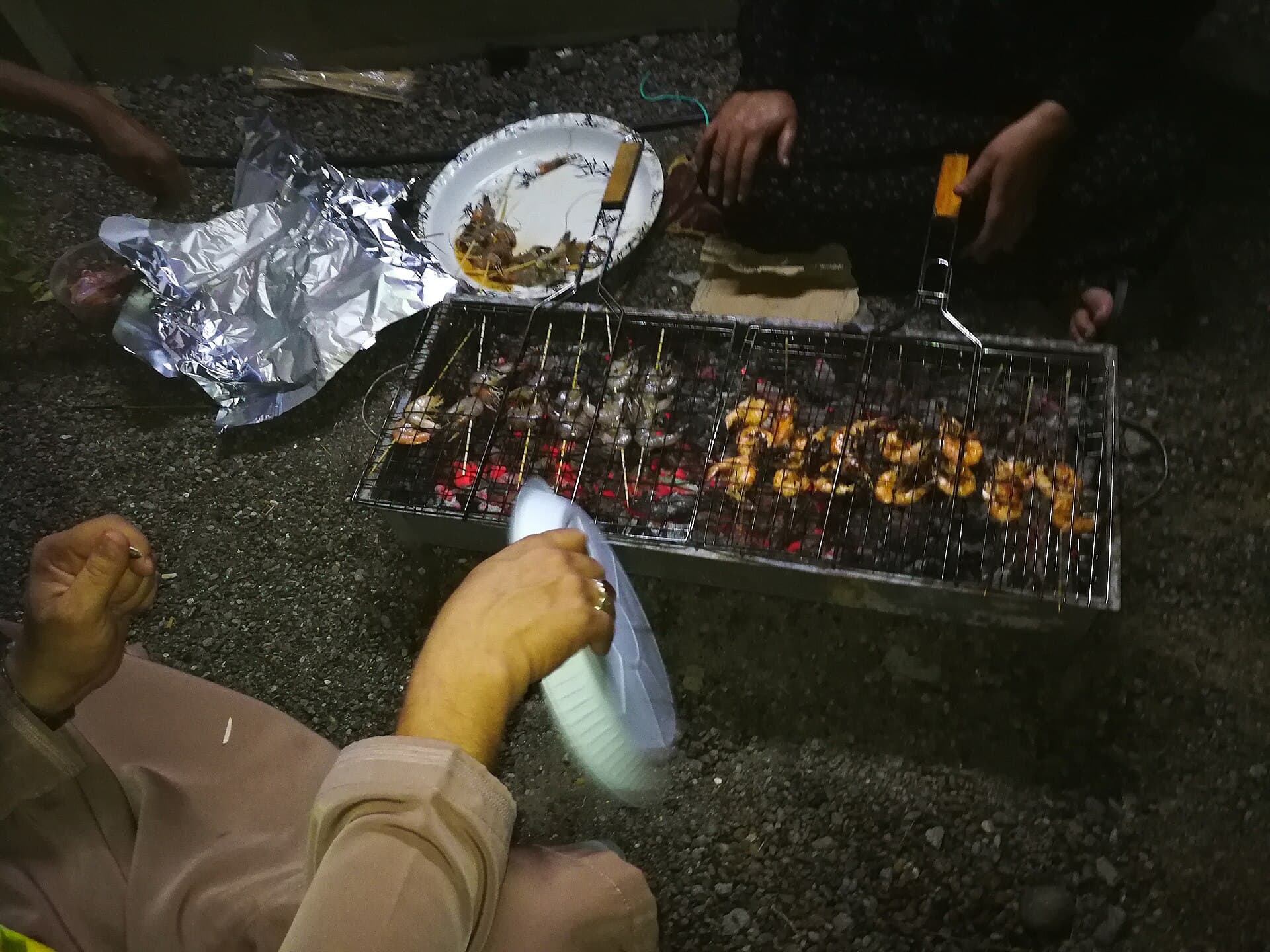 Omani mishkak skewers cooking over charcoal